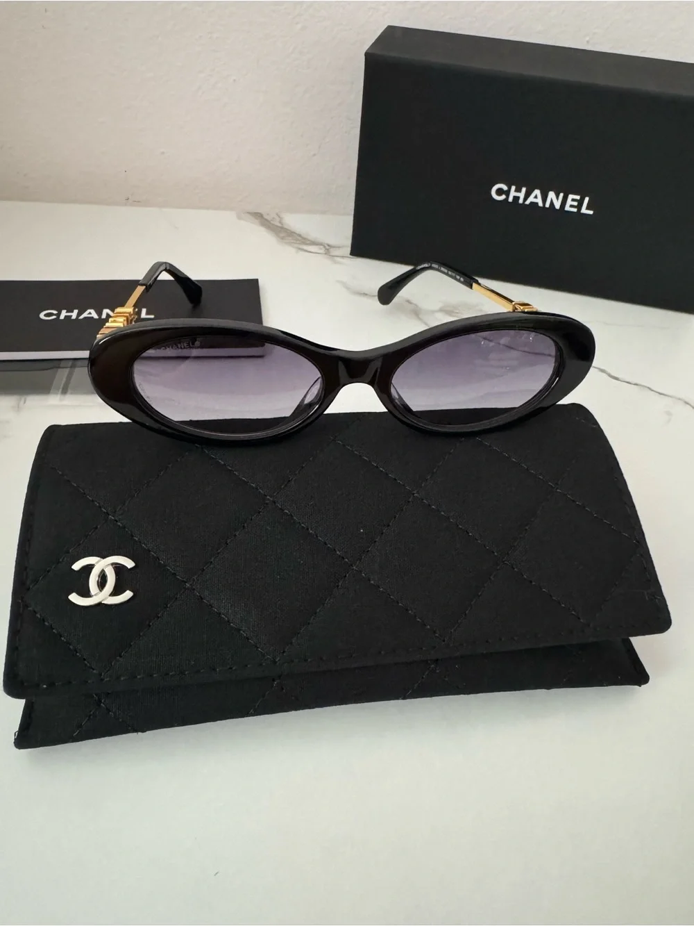 CHANEL Black Oval Sunglasses with Gray Gradient Lenses